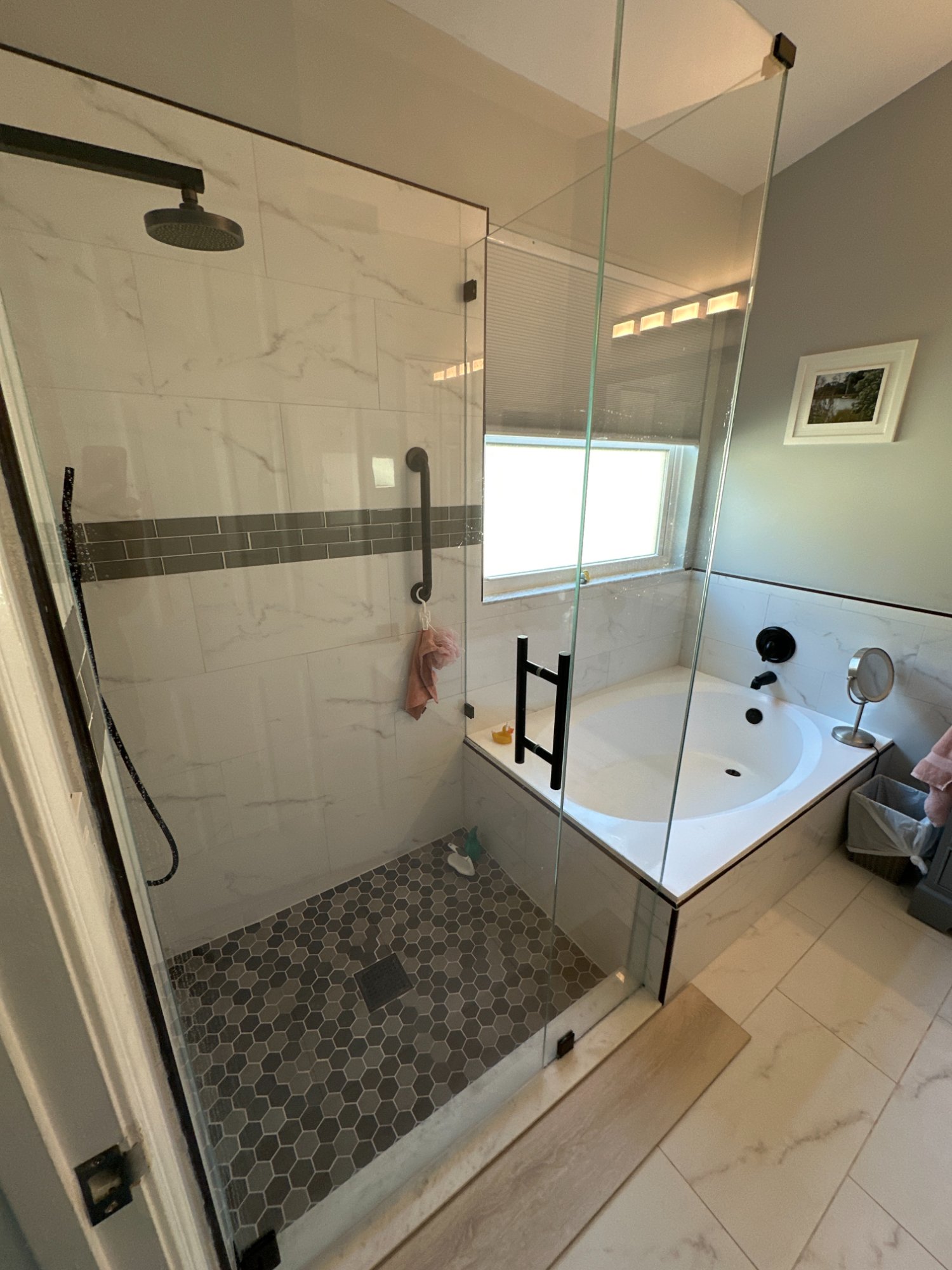 Master bathroom before — full view showing original layout with dated gray cabinet and brushed nickel hardware