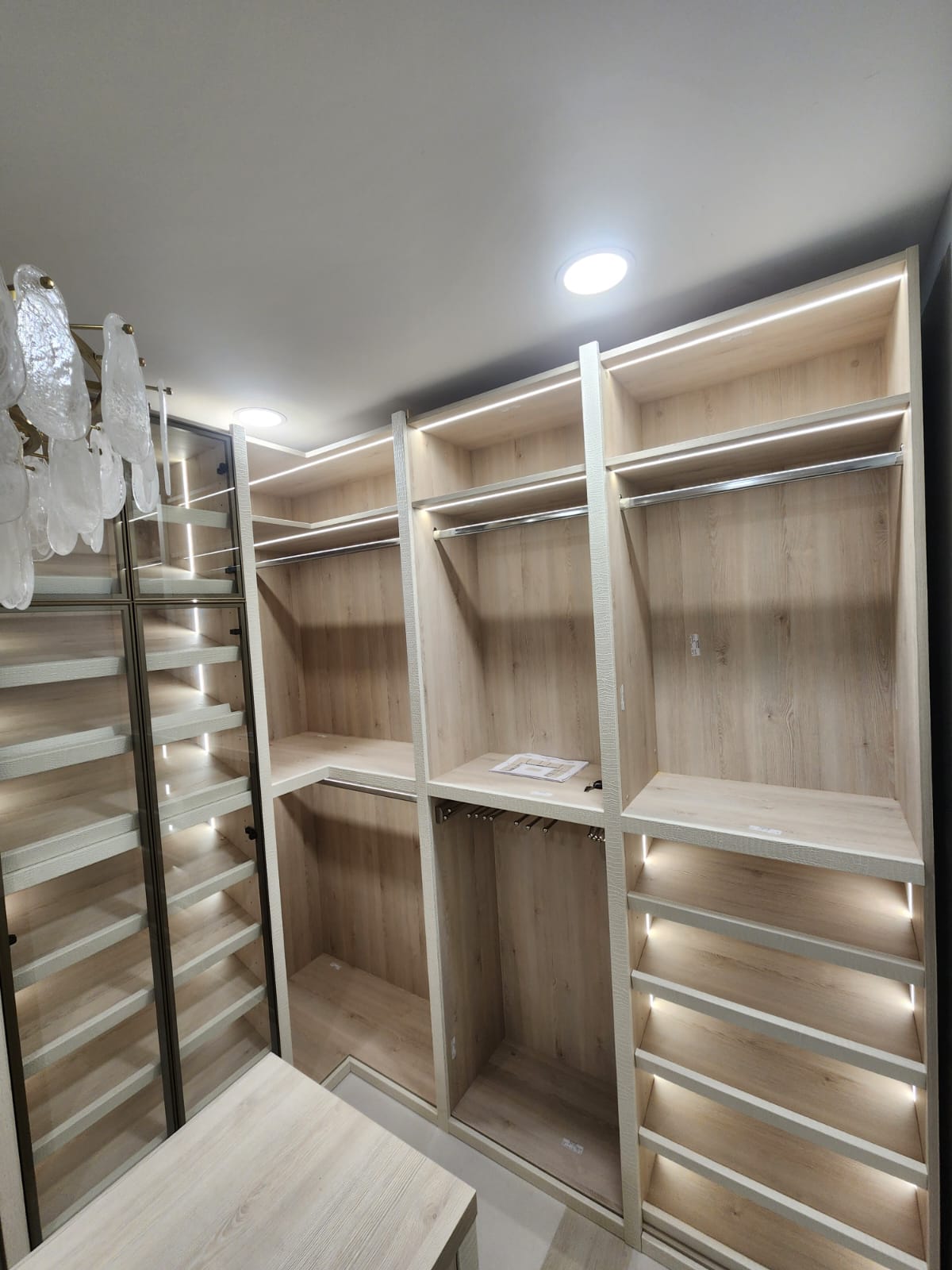 Custom closets Palm Beach County — walk-in closet with glass-front tower cabinets