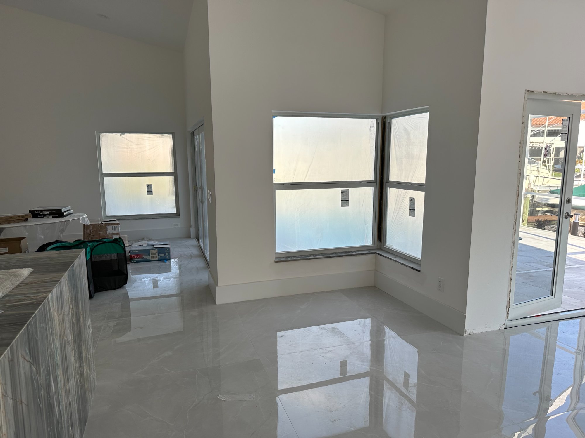 Kitchen after — Café refrigerator with brushed bronze handles, white shaker cabinets to ceiling
