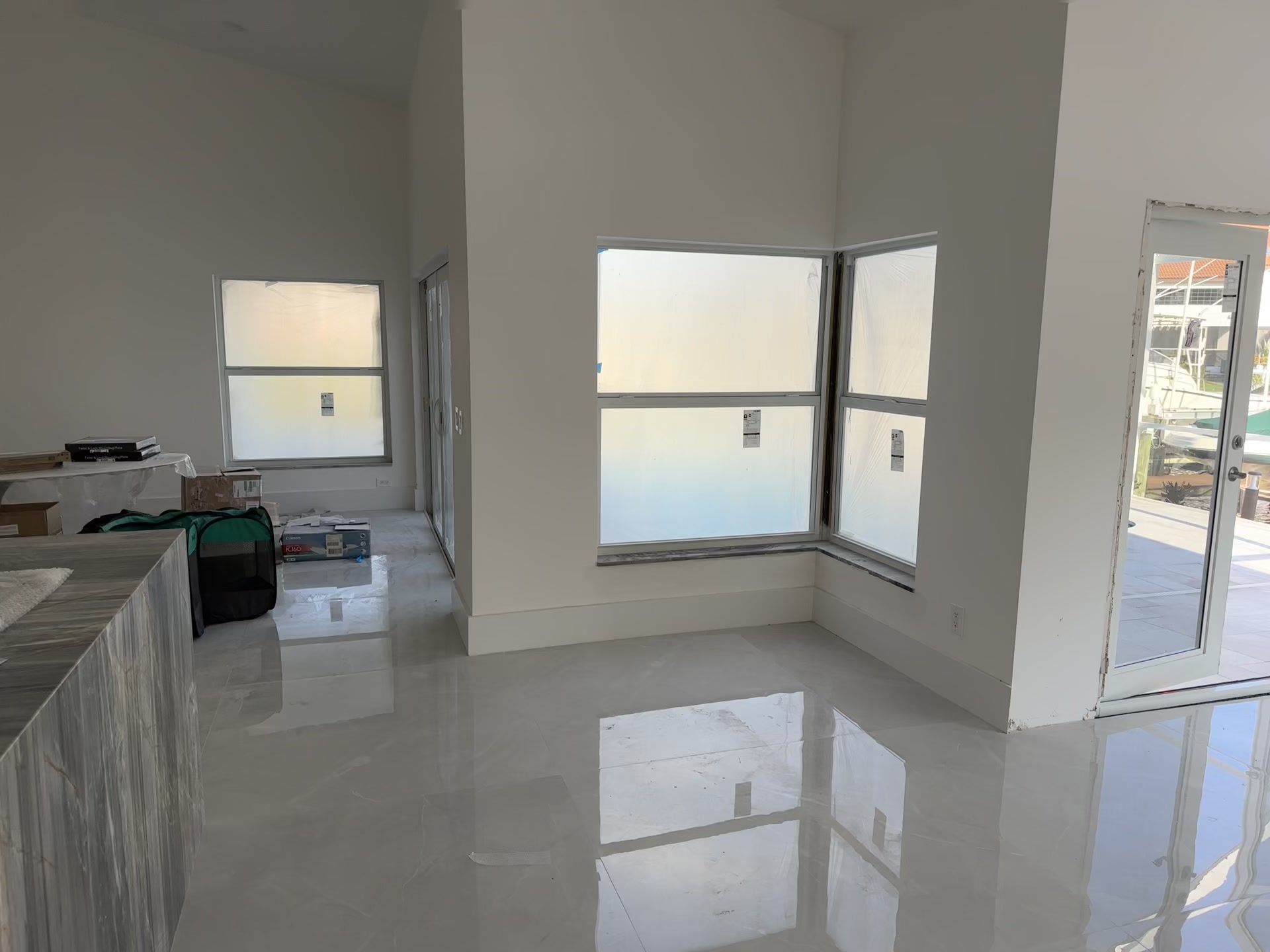 Kitchen after remodel walkthrough — white shaker cabinets, Café appliances, open plan waterfront view