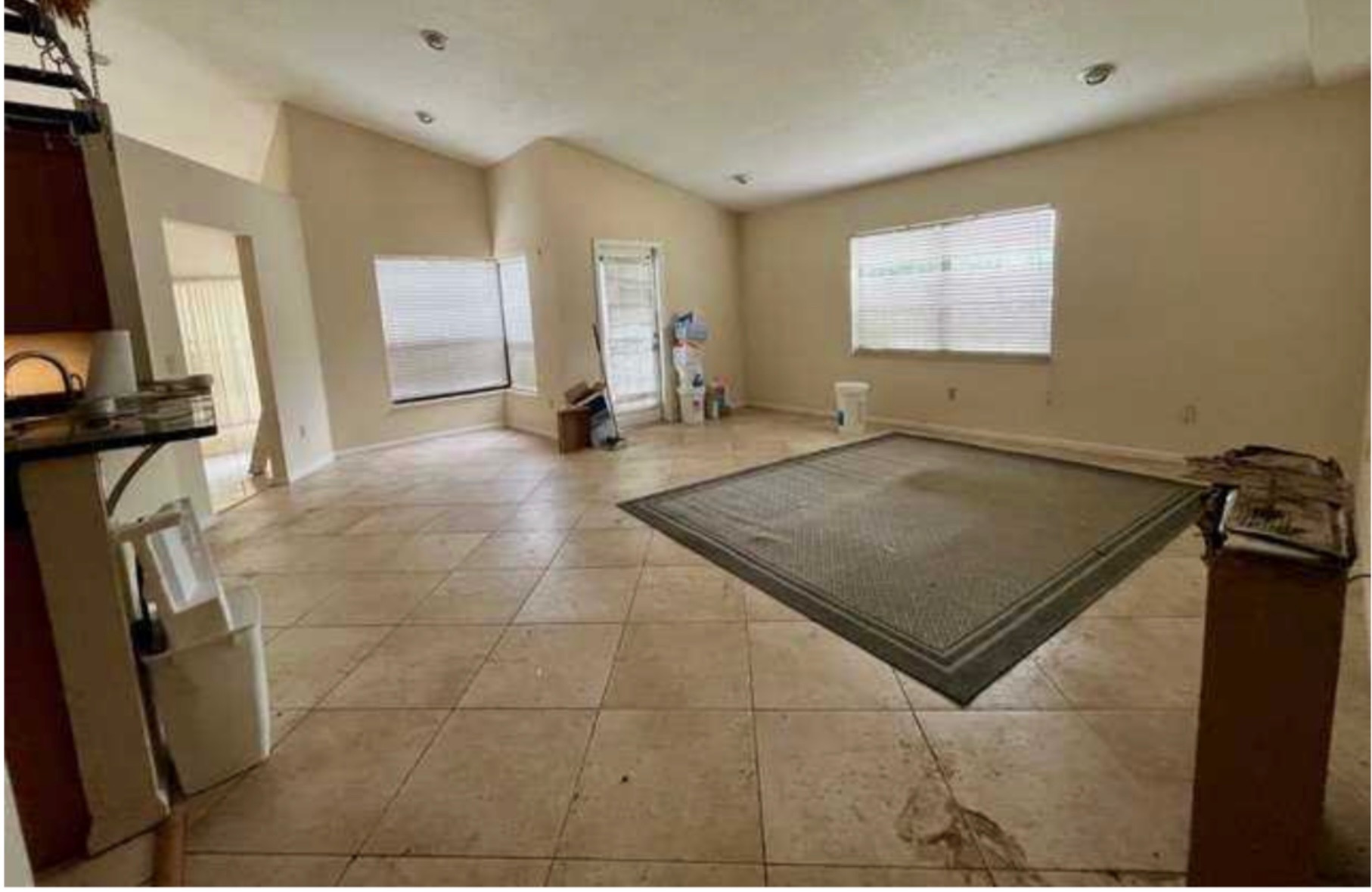Kitchen before remodel — honey oak shaker cabinets, black granite countertops, pot rack