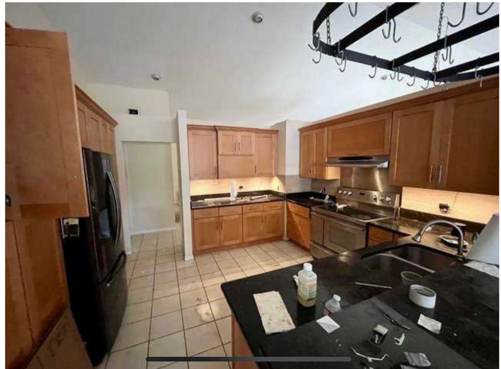 Kitchen before — Samsung black stainless refrigerator, honey oak cabinets